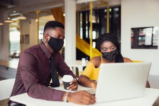 african-students-with-friends-wearing-mask-sitting-at-desk-at-modern-school-virus-protection-at_t20_ml6Bvd