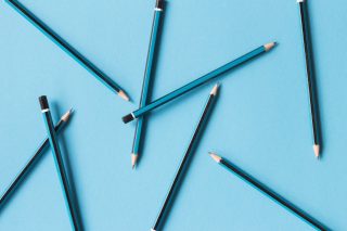 blue-and-black-pencils-on-blue-background-abstract_t20_Zzlnpj