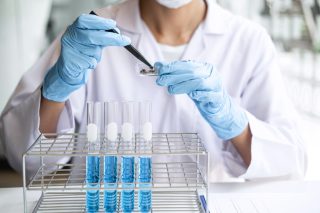 scientist-or-medical-in-lab-testing-sample-trial-with-reagent-mixing-reagents-in-glass-flask_t20_G0dr9m