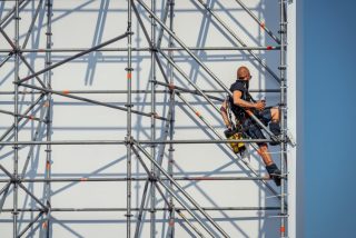 scaffold-builders-occupation-worker-setting-up-scaffolding-a-temporary-structure-of-metal-poles-and_t20_G0LveE