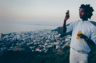 young-african-adult-taking-photo-of-city-with-his-smartphone_t20_7JV7VZ