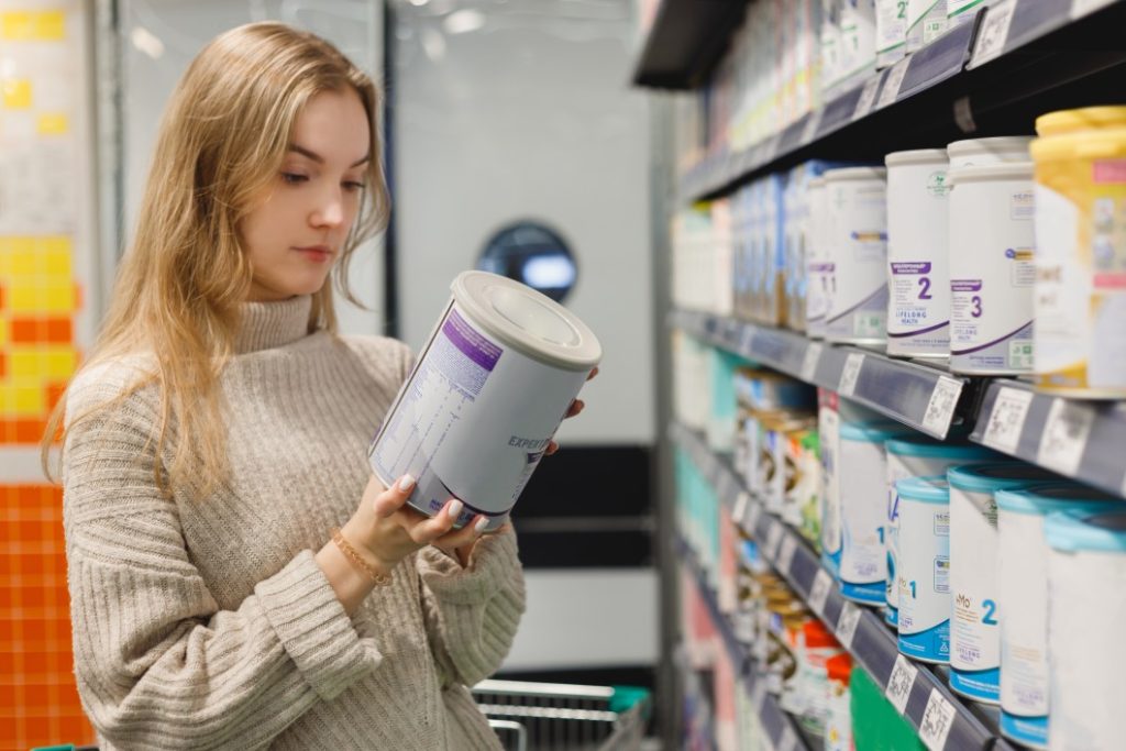 Women buys infant milk formula at the supermarket